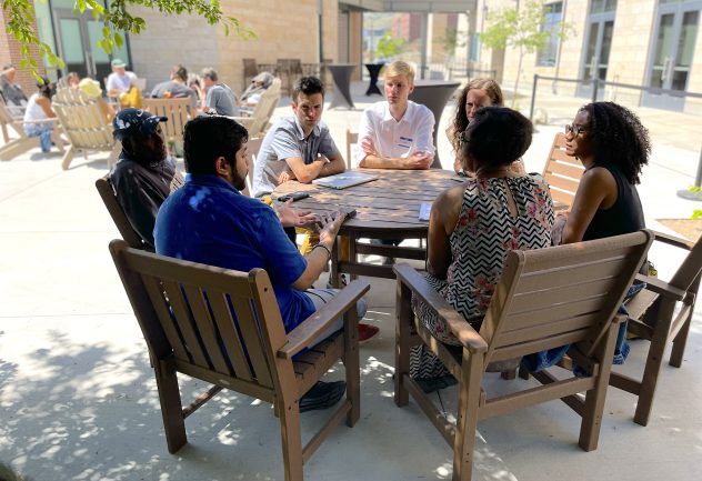 Group of people at table talking.